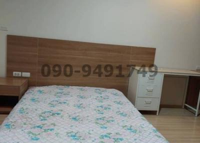 Cosy bedroom interior with large bed and air conditioning unit