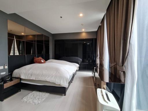 Spacious bedroom with modern design and large windows