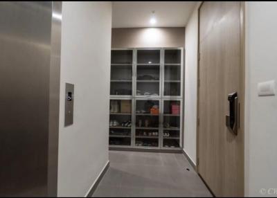 Modern entryway with built-in shoe cabinet and wooden door