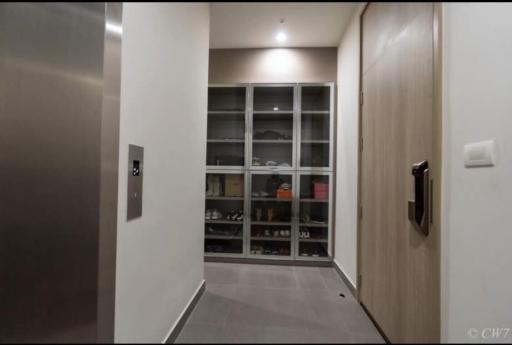 Modern entryway with built-in shoe cabinet and wooden door