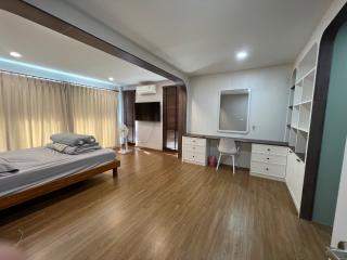 Spacious modern bedroom with large bed and ample shelving