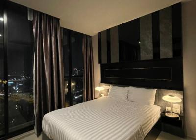 Contemporary bedroom with city view at night