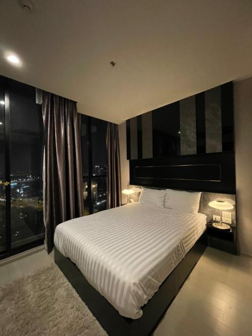 Contemporary bedroom with city view at night