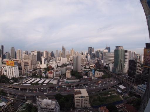 Aerial view of a bustling cityscape with high-rise buildings and busy streets