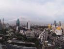 Panoramic view of a bustling cityscape under cloudy skies