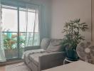 Cozy living room with natural light and balcony view