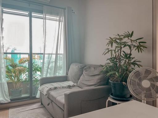 Cozy living room with natural light and balcony view