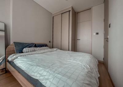 Modern bedroom with a large bed and built-in wardrobes