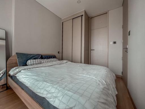 Modern bedroom with a large bed and built-in wardrobes