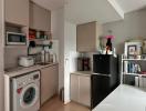 Compact modern kitchen with integrated appliances and white countertops