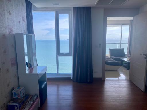 Coastal bedroom with ocean view and balcony access