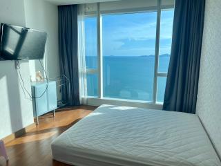 Bright bedroom with ocean view and large windows