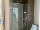 Modern bathroom with glass shower enclosure and mosaic tiles