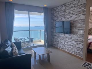 Cozy living room with a beautiful ocean view, comfortable seating and natural light