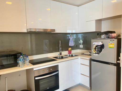 Modern kitchen with white cabinets and stainless steel appliances