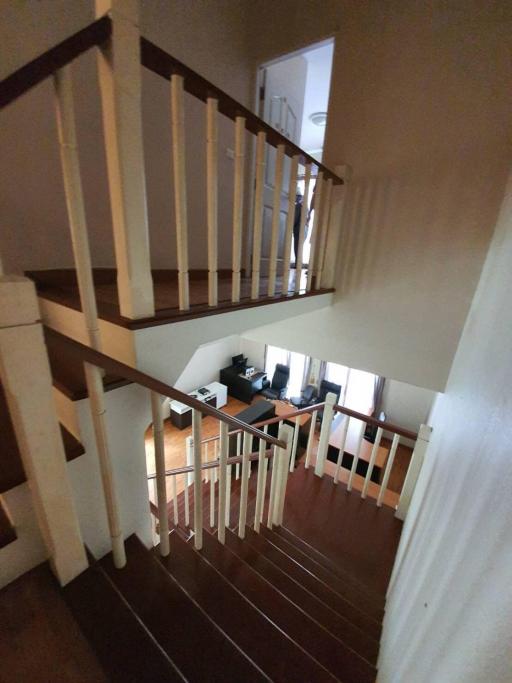 Picture of a staircase inside a house showing wooden steps and railing