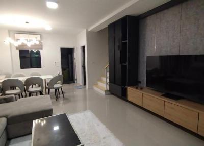 Spacious modern living room with dining area and large entertainment unit