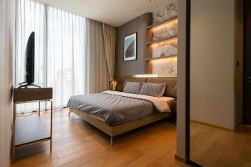 Modern bedroom with large window and art on the wall