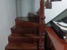 Wooden staircase with varnished balusters in a home interior