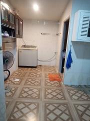 Compact kitchen with appliances and tiled flooring