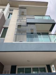 Modern multi-story residential building with balconies and large windows