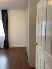 Bright bedroom with hardwood floors and built-in closet space