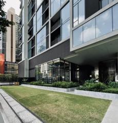 Modern residential building exterior with landscaped garden