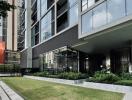 Modern residential building exterior with landscaped garden