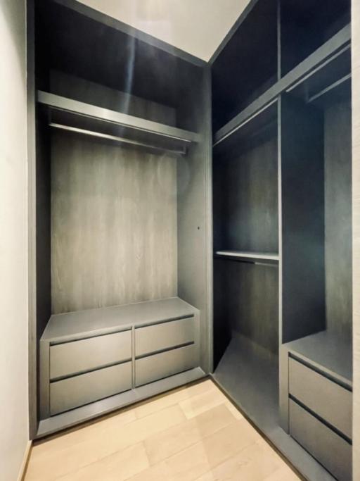 Modern empty walk-in closet with built-in cabinets