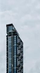 Modern high-rise residential building against a cloudy sky