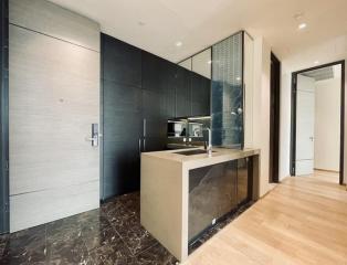 Modern kitchen with marble countertops and wooden flooring