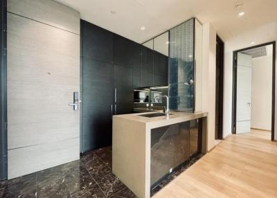 Modern kitchen with integrated appliances and marble flooring