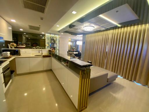 Modern kitchen with bar counter in a well-lit interior