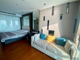 Modern bedroom with an adjacent sitting area and large windows