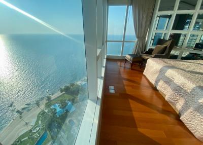 Spacious bedroom with ocean view and large windows