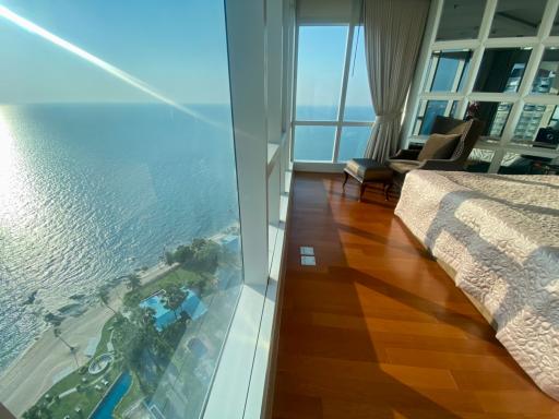 Spacious bedroom with ocean view and large windows