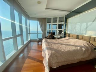 Spacious bedroom with natural light and sea view