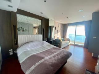 Spacious bedroom with large bed, natural light, and ocean view