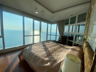 Cozy bedroom with a panoramic sea view and ample sunlight