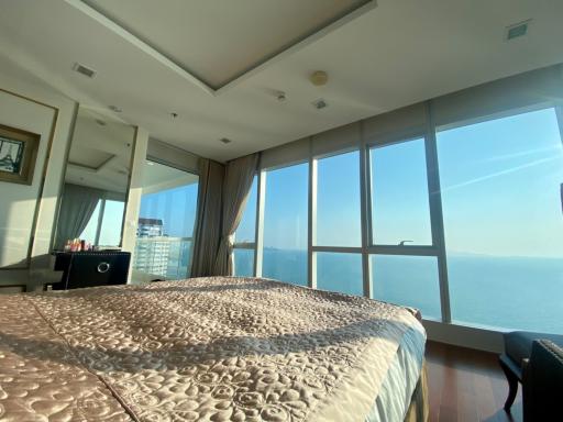 Spacious bedroom with a large bed and panoramic sea view