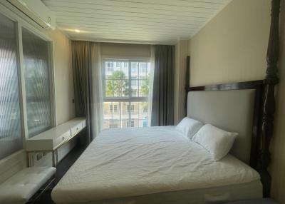 Spacious bedroom with natural lighting and balcony view