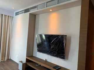 Modern living room interior with wall-mounted television and ambient lighting