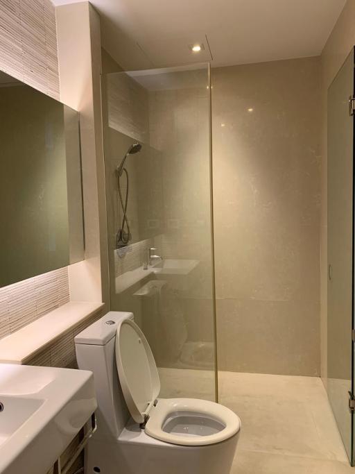 Modern bathroom with glass shower enclosure and toilet