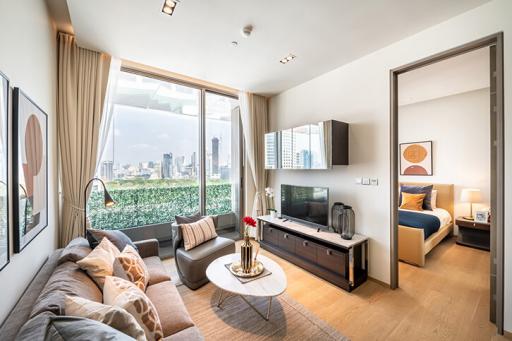 Modern living room with open view to the bedroom and cityscape
