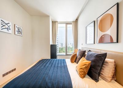 Modern bedroom with large window and artwork