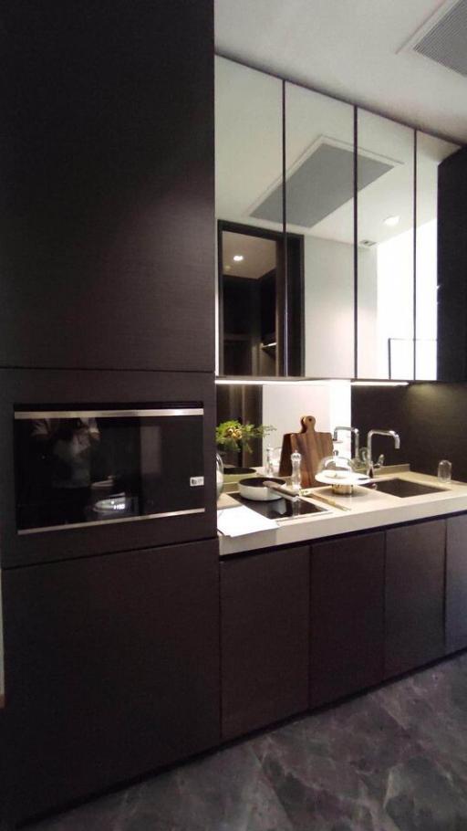 Modern kitchen with black cabinets and built-in appliances