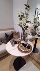 Elegantly set table within a modern dining space with cozy seating