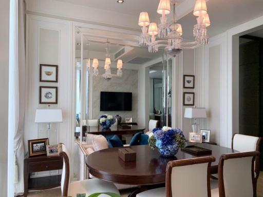 Elegant living room with dining area and mirrored wall