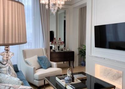 Elegant living room with modern furnishings and a chandelier