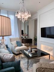 Elegant living room with modern furnishings and a chandelier